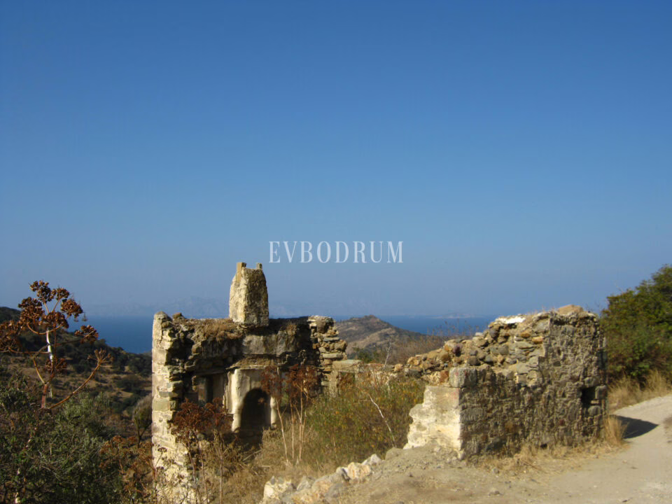 Ancient stone remains at Gümüşlük — the Myndos heritage, with the sea and islands behind